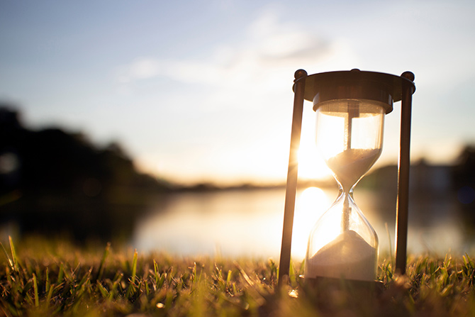 President's Message hourglass on grass