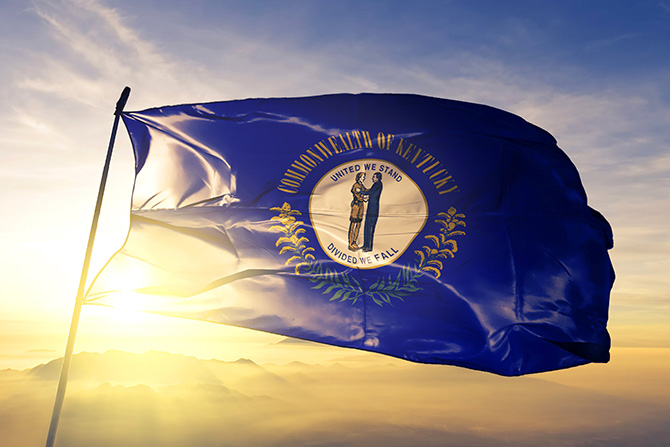 Virginia flag waving in front of the sun