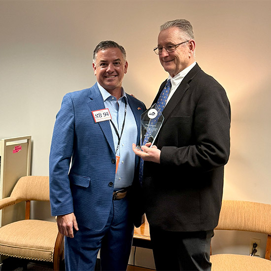 Sen. Higdon receiving award from KADA